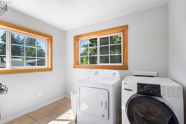 108 SE 133rd Ave, Portland, OR 97233 - washroom featuring separate washer and dryer, laundry area, plenty of natural light, and light tile patterned flooring
