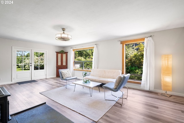 108 SE 133rd Ave, Portland, OR 97233 - living room featuring baseboards, wood finished floors, and a healthy amount of sunlight