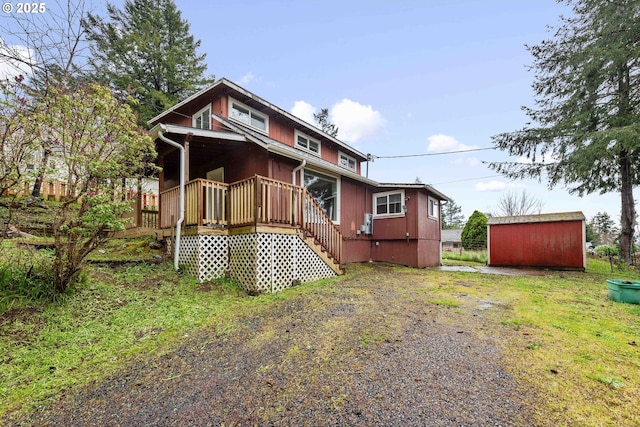 back of property featuring an outbuilding