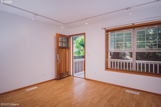 7942 N Hurst Ave, Portland, OR 97203 - empty room with track lighting, light wood-style flooring, and baseboards