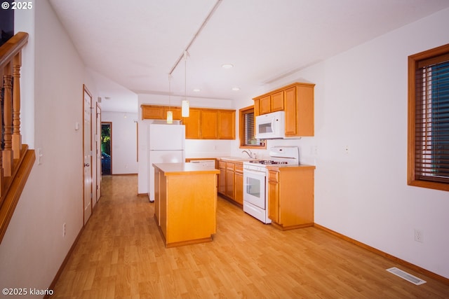 7942 N Hurst Ave, Portland, OR 97203 - kitchen with white appliances, a sink, light wood-type flooring, light countertops, and recessed lighting