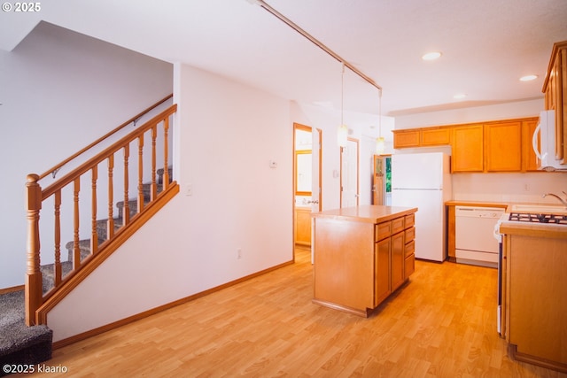 7942 N Hurst Ave, Portland, OR 97203 - kitchen featuring white appliances, a center island, light wood-type flooring, recessed lighting, and light countertops