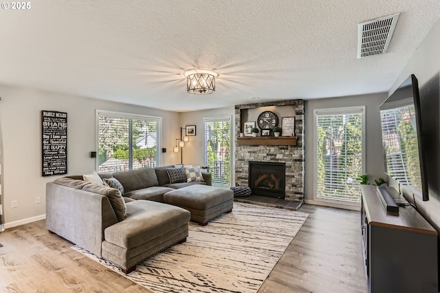 1736 Regency St, West Linn, OR 97068 - living area featuring light wood-style flooring, a textured ceiling, and a fireplace