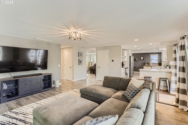 1736 Regency St, West Linn, OR 97068 - living area featuring light wood-style flooring, recessed lighting, and a chandelier