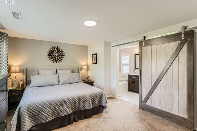 1736 Regency St, West Linn, OR 97068 - bedroom featuring a barn door, light carpet, and connected bathroom