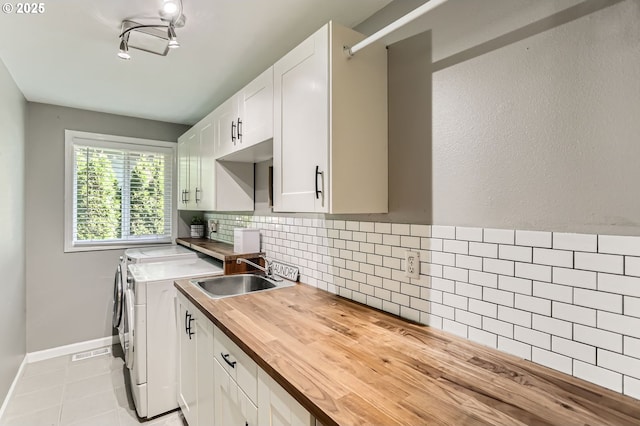 1736 Regency St, West Linn, OR 97068 - laundry room with washer and dryer, cabinet space, and light tile patterned floors