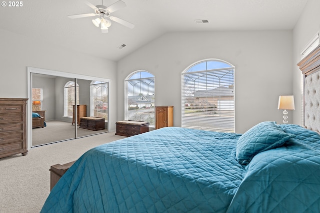 carpeted bedroom featuring ceiling fan, a closet, and vaulted ceiling