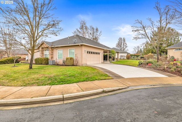 view of front of property with cooling unit, a garage, and a front yard