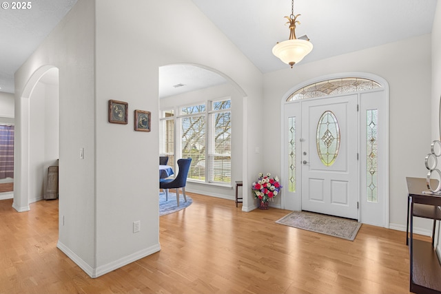 entrance foyer featuring light hardwood / wood-style floors and vaulted ceiling