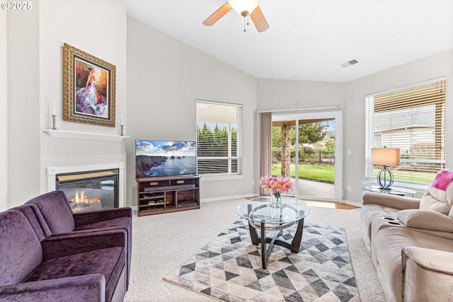 living room with carpet flooring, ceiling fan, and lofted ceiling