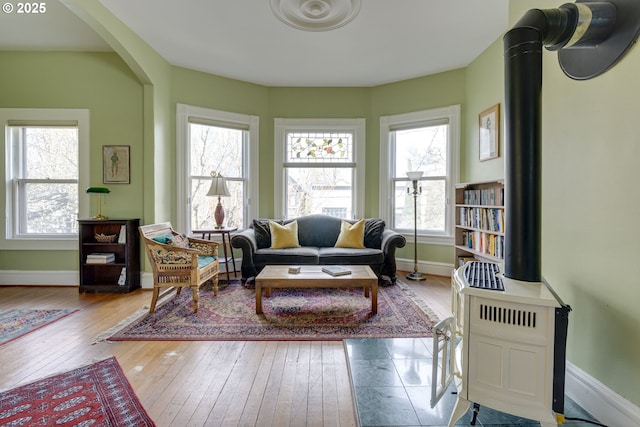 2122 NW Everett St, Portland, OR 97210 - living area with wood-type flooring, baseboards, and a baseboard heating unit