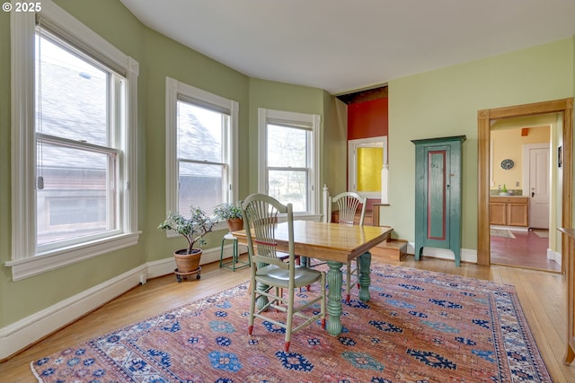 2122 NW Everett St, Portland, OR 97210 - dining space with light wood-style floors and baseboards