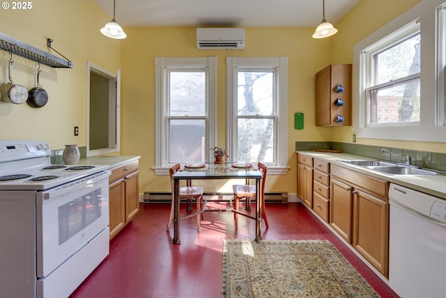2122 NW Everett St, Portland, OR 97210 - kitchen with white appliances, a sink, a wall unit AC, light countertops, and decorative light fixtures