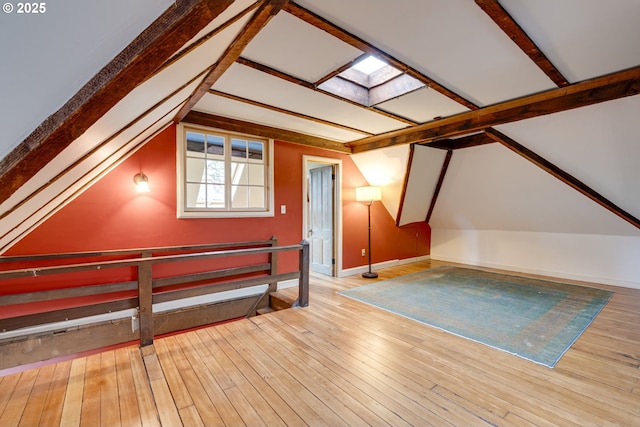2122 NW Everett St, Portland, OR 97210 - additional living space featuring a skylight, hardwood / wood-style flooring, vaulted ceiling, and baseboards