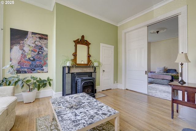 2122 NW Everett St, Portland, OR 97210 - living area featuring wood finished floors, ornamental molding, a fireplace with flush hearth, and baseboards