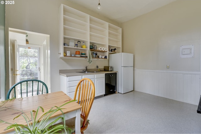 2122 NW Everett St, Portland, OR 97210 - kitchen featuring freestanding refrigerator, black dishwasher, a wainscoted wall, a sink, and open shelves