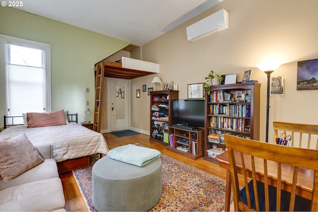 2122 NW Everett St, Portland, OR 97210 - bedroom with a wall unit AC and wood finished floors