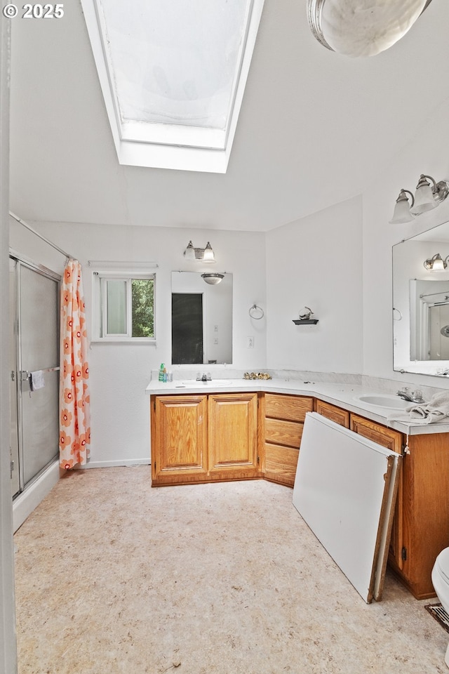 58897 Constance Dr, Bandon, OR 97411 - bathroom featuring a skylight, a shower with curtain, and double vanity