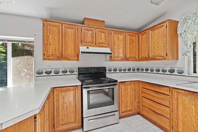 58897 Constance Dr, Bandon, OR 97411 - kitchen featuring stainless steel electric stove, exhaust hood, light countertops, light floors, and a peninsula