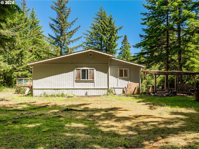 58897 Constance Dr, Bandon, OR 97411 - view of side of home featuring a wooden deck