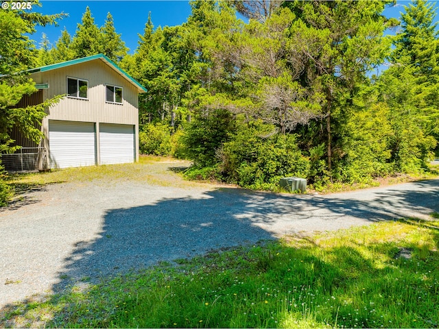 58897 Constance Dr, Bandon, OR 97411 - view of home's exterior featuring gravel driveway and an attached garage