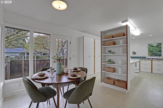 dining space featuring light floors