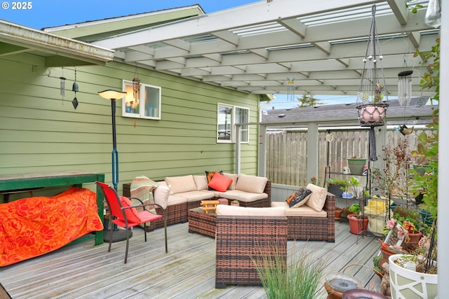 wooden deck with an outdoor hangout area and fence