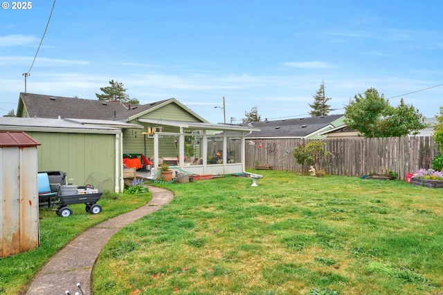 back of house with fence, a yard, and a sunroom