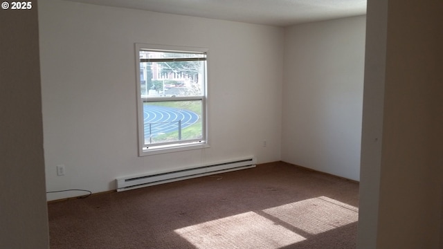 empty room featuring baseboard heating, a healthy amount of sunlight, and dark colored carpet