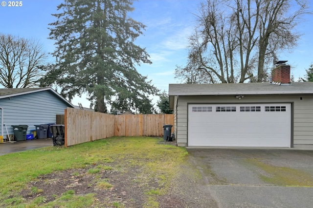 detached garage featuring fence