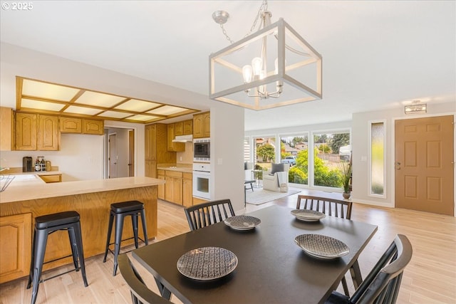 1725 SE Cochran Dr, Gresham, OR 97080 - dining area featuring light wood-type flooring and a chandelier