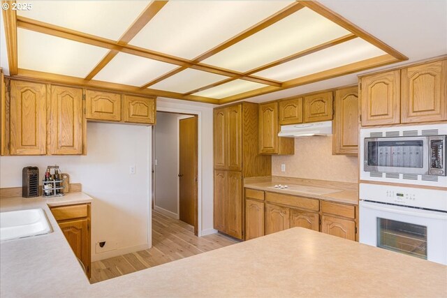 1725 SE Cochran Dr, Gresham, OR 97080 - kitchen featuring stainless steel microwave, oven, light wood-style flooring, under cabinet range hood, and light countertops