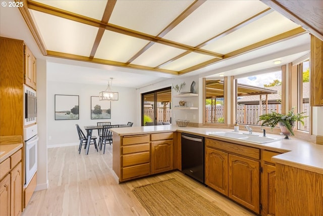 1725 SE Cochran Dr, Gresham, OR 97080 - kitchen with dishwasher, built in microwave, light wood-style flooring, a peninsula, and light countertops