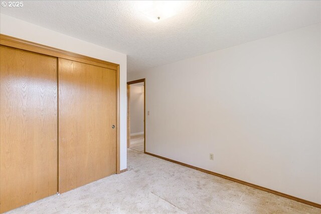 1725 SE Cochran Dr, Gresham, OR 97080 - unfurnished bedroom with a closet, light carpet, and a textured ceiling