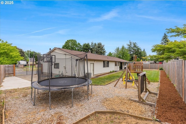 1725 SE Cochran Dr, Gresham, OR 97080 - rear view of property featuring a trampoline, a playground, and a fenced backyard