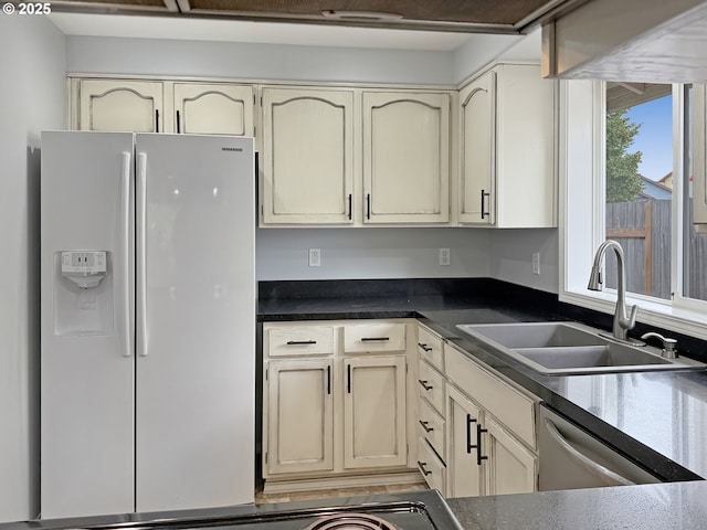 573 SE 73rd Ave, Hillsboro, OR 97123 - kitchen featuring white fridge with ice dispenser, cream cabinetry, stainless steel dishwasher, and dark countertops