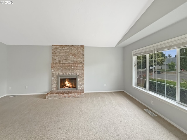 573 SE 73rd Ave, Hillsboro, OR 97123 - unfurnished living room featuring vaulted ceiling, a brick fireplace, and carpet flooring