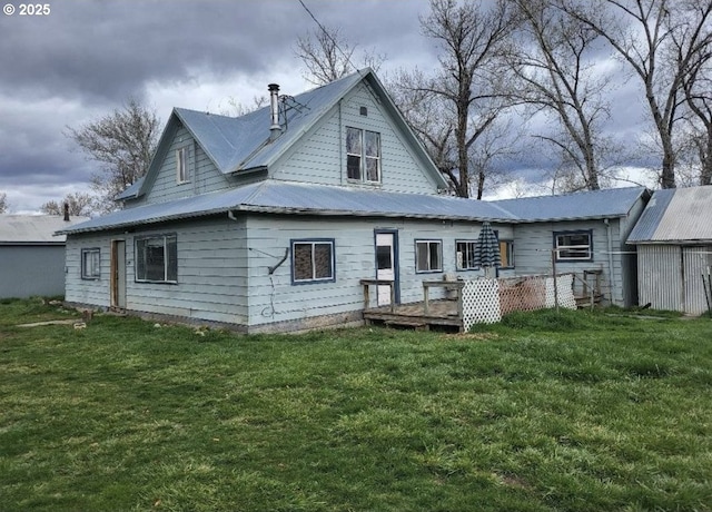 rear view of property featuring a lawn