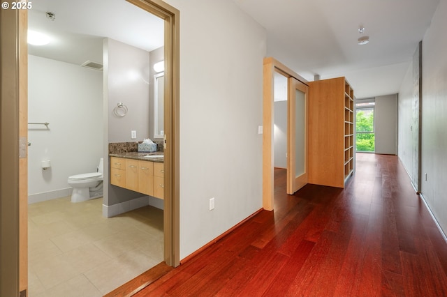 1221 SW 10th Ave Unit 311, Portland, OR 97205 - hallway featuring baseboards and wood finished floors