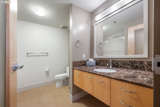 1221 SW 10th Ave Unit 311, Portland, OR 97205 - full bath featuring vanity, toilet, baseboards, and tile patterned flooring
