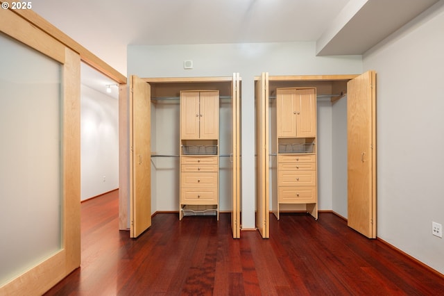 1221 SW 10th Ave Unit 311, Portland, OR 97205 - unfurnished bedroom featuring dark wood finished floors and multiple closets
