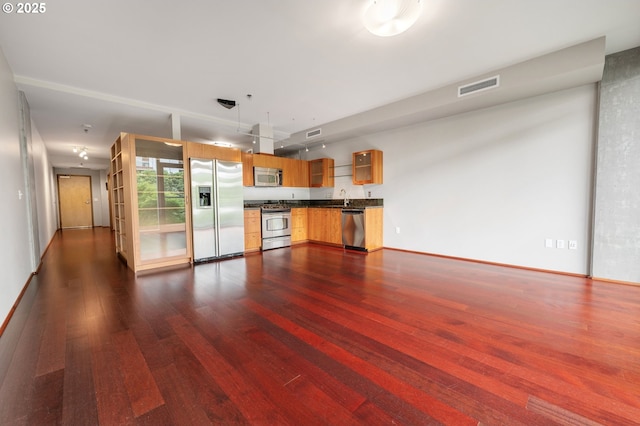 1221 SW 10th Ave Unit 311, Portland, OR 97205 - unfurnished living room with dark wood finished floors, a sink, and baseboards
