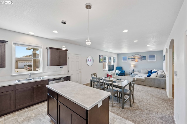 764 Seacrest Dr, Bandon, OR 97411 - kitchen with a sink, dark brown cabinetry, arched walkways, recessed lighting, and light countertops