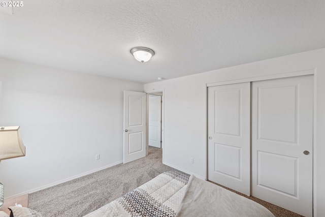 764 Seacrest Dr, Bandon, OR 97411 - unfurnished bedroom featuring carpet flooring, baseboards, a closet, and a textured ceiling
