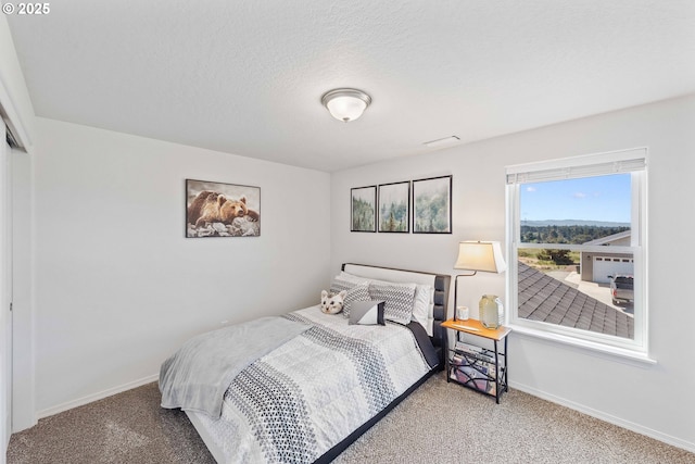 764 Seacrest Dr, Bandon, OR 97411 - carpeted bedroom featuring baseboards and a textured ceiling