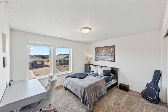 764 Seacrest Dr, Bandon, OR 97411 - carpeted bedroom featuring a desk, a textured ceiling, and baseboards