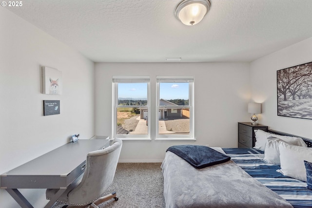 764 Seacrest Dr, Bandon, OR 97411 - carpeted bedroom with a textured ceiling, an office area, and baseboards