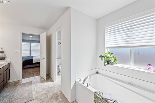 764 Seacrest Dr, Bandon, OR 97411 - ensuite bathroom featuring a garden tub, vanity, toilet, and plenty of natural light