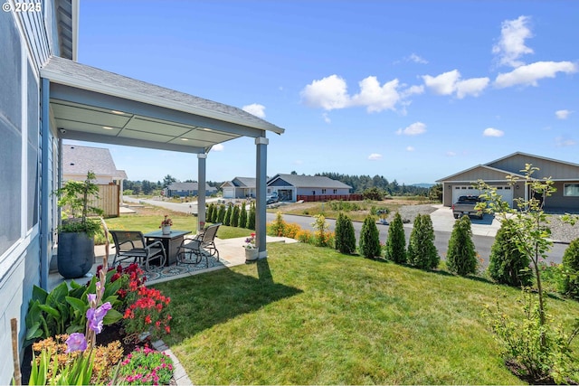 764 Seacrest Dr, Bandon, OR 97411 - view of grassy yard featuring a patio and a garage