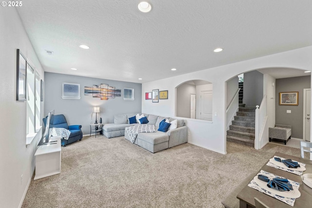 764 Seacrest Dr, Bandon, OR 97411 - living room with arched walkways, carpet flooring, baseboards, recessed lighting, and a textured ceiling